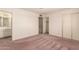 Bedroom featuring carpet flooring, neutral paint, a closet, and a bright window at 6027 E Ellis St, Mesa, AZ 85204
