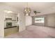 Dining and living room combination highlighting chandelier, ceiling fan and retro kitchen at 6027 E Ellis St, Mesa, AZ 85204