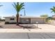 Charming single-story home with a well-maintained front yard, desert landscaping and a classic desert tree at 6027 E Ellis St, Mesa, AZ 85204