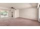Spacious living room featuring carpet flooring, neutral paint and a large window providing natural light at 6027 E Ellis St, Mesa, AZ 85204