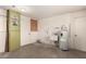A utility room with a water heater, utility sink, and green storage cabinet at 6027 E Ellis St, Mesa, AZ 85204