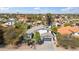 An aerial shot highlights a home with a grey roof, surrounded by lush landscaping and neighboring houses at 6164 E Greenway Ln, Scottsdale, AZ 85254
