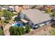 Aerial view of a backyard pool with lounge chairs and patio, surrounded by a brick fence and lush trees at 6164 E Greenway Ln, Scottsdale, AZ 85254