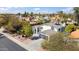 Elevated angle showing a home with mature trees, landscaped yard and a dark grey roof at 6164 E Greenway Ln, Scottsdale, AZ 85254