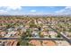 Wide aerial view of a residential area with many homes, streets, and distant mountains at 6164 E Greenway Ln, Scottsdale, AZ 85254