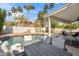 Palm trees and desert landscaping surround outdoor living space with pool and patio at 6164 E Greenway Ln, Scottsdale, AZ 85254