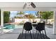 Outdoor living space with covered patio offers views of the pool and desert landscaping at 6164 E Greenway Ln, Scottsdale, AZ 85254