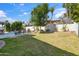 Expansive backyard with lush lawn, mature trees, and a sparkling pool offers space to enjoy at 6164 E Greenway Ln, Scottsdale, AZ 85254