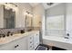 Bathroom features a double sink vanity, soaking tub, and decorative lighting at 6164 E Greenway Ln, Scottsdale, AZ 85254
