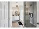 Modern bathroom with double vanity, bathtub, beautiful chandelier and glass-enclosed shower at 6164 E Greenway Ln, Scottsdale, AZ 85254