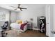 Bright bedroom features wood floors, a ceiling fan, and neutral decor at 6164 E Greenway Ln, Scottsdale, AZ 85254