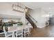 Bright dining room features modern light fixture, hardwood floors and staircase at 6164 E Greenway Ln, Scottsdale, AZ 85254