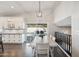 Dining area boasts wood floors, a pool view, and a modern pendant light at 6164 E Greenway Ln, Scottsdale, AZ 85254