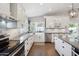 Well-lit kitchen featuring stainless steel appliances, white cabinetry, and a farmhouse sink at 6164 E Greenway Ln, Scottsdale, AZ 85254