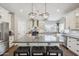 Stylish kitchen boasting a center island, modern lighting, and stainless steel appliances at 6164 E Greenway Ln, Scottsdale, AZ 85254