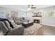 Cozy living room with a plush gray sofa, fireplace, and neutral decor at 6164 E Greenway Ln, Scottsdale, AZ 85254
