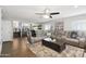 Spacious living room with fireplace, gray sectional sofa, and wood floors at 6164 E Greenway Ln, Scottsdale, AZ 85254