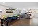 Open living area with wood floors, an air hockey table, and comfortable seating at 6164 E Greenway Ln, Scottsdale, AZ 85254