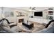 Comfortable living room boasts a fireplace, built-ins, and wood-look floors at 6164 E Greenway Ln, Scottsdale, AZ 85254
