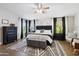 Spacious main bedroom with dark furniture, patterned rug and lots of natural light at 6164 E Greenway Ln, Scottsdale, AZ 85254