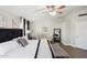Bright main bedroom with ceiling fan, sitting area, and hardwood floors at 6164 E Greenway Ln, Scottsdale, AZ 85254