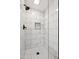 Modern bathroom with black fixtures, rain shower head and subway tile walls at 6164 E Greenway Ln, Scottsdale, AZ 85254