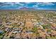 Extensive aerial view of the desert community with many homes and distant mountains at 639 N 102Nd Pl, Mesa, AZ 85207