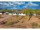 Beautiful aerial view showcasing a charming desert home with cacti, native vegetation, and mountain views at 639 N 102Nd Pl, Mesa, AZ 85207