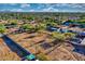 Expansive desert lot view featuring neighborhood homes and utility vehicles at 639 N 102Nd Pl, Mesa, AZ 85207