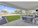 Outdoor seating area looks out on the manicured artificial lawn and expansive backyard at 639 N 102Nd Pl, Mesa, AZ 85207