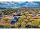 Aerial view showcasing home's pool and shaded patio against a mountain backdrop at 639 N 102Nd Pl, Mesa, AZ 85207