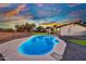 Backyard oasis featuring a sparkling pool, covered patio, and lush green space, ideal for relaxing and entertaining at 639 N 102Nd Pl, Mesa, AZ 85207
