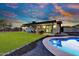 Stunning backyard with lush lawn, inviting pool, and covered patio, perfect for outdoor living at 639 N 102Nd Pl, Mesa, AZ 85207