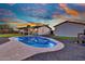 Gorgeous pool area with a kidney-shaped pool, complemented by a well-manicured lawn and spacious backyard at 639 N 102Nd Pl, Mesa, AZ 85207