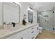 Modern bathroom with double vanity, marble countertop, and stylish lighting fixtures at 639 N 102Nd Pl, Mesa, AZ 85207
