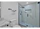 Bathroom with walk-in shower featuring a rainfall shower head and mosaic tile flooring at 639 N 102Nd Pl, Mesa, AZ 85207