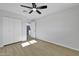 Minimalist bedroom features a ceiling fan, large closet, and neutral paint color at 639 N 102Nd Pl, Mesa, AZ 85207