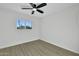 Sunlit bedroom features wood-look floors and a window overlooking desert plants at 639 N 102Nd Pl, Mesa, AZ 85207