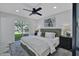 Bright bedroom with a ceiling fan and sliding glass door to the backyard at 639 N 102Nd Pl, Mesa, AZ 85207