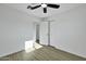 Neutral bedroom with wood-look floors, ceiling fan, and closet space at 639 N 102Nd Pl, Mesa, AZ 85207