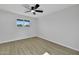 Minimalist bedroom featuring a ceiling fan, neutral paint, and a large window offering natural light at 639 N 102Nd Pl, Mesa, AZ 85207