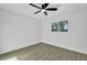 Bedroom featuring a desert view, wood-look floors, and a ceiling fan at 639 N 102Nd Pl, Mesa, AZ 85207