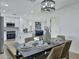 Dining room features a table with seating, modern lighting, and a view into the kitchen at 639 N 102Nd Pl, Mesa, AZ 85207