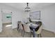 Bright dining room featuring modern lighting, table with seating for six, and neutral décor at 639 N 102Nd Pl, Mesa, AZ 85207