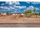 View of home with detached garage, desert landscaping, new roof, and new exterior paint at 639 N 102Nd Pl, Mesa, AZ 85207