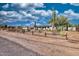 Wide angle view of home with detached garage, desert landscaping, a new roof, and new exterior paint at 639 N 102Nd Pl, Mesa, AZ 85207