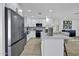 Bright kitchen with a center island features stainless appliances, white cabinets, and modern finishes at 639 N 102Nd Pl, Mesa, AZ 85207