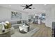 Bright, open-concept living room flows into a modern kitchen with white cabinets and stainless appliances at 639 N 102Nd Pl, Mesa, AZ 85207