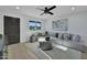 Living room offers stylish decor, neutral colors, wood-look floors, and backyard views from the window at 639 N 102Nd Pl, Mesa, AZ 85207