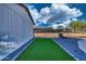 Neat side yard with artificial turf, enclosed by a fence, offering a low-maintenance green space at 639 N 102Nd Pl, Mesa, AZ 85207